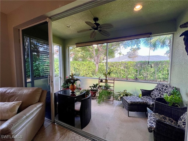 sunroom / solarium featuring ceiling fan