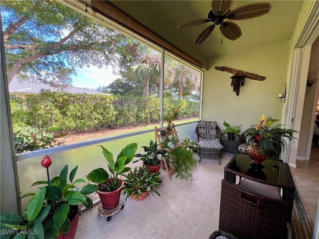 sunroom / solarium featuring ceiling fan