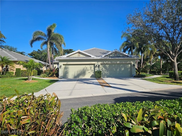 view of front of house with a front lawn and a garage