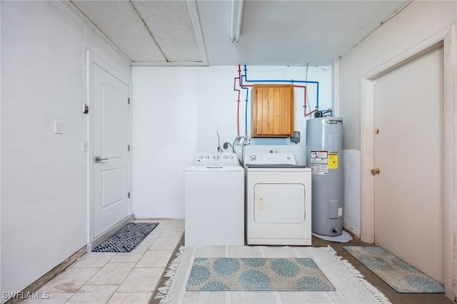 laundry area featuring light tile patterned floors, washer and clothes dryer, and electric water heater