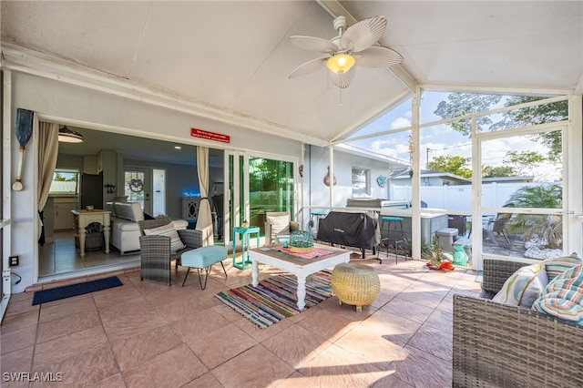 sunroom featuring lofted ceiling, a wealth of natural light, and ceiling fan