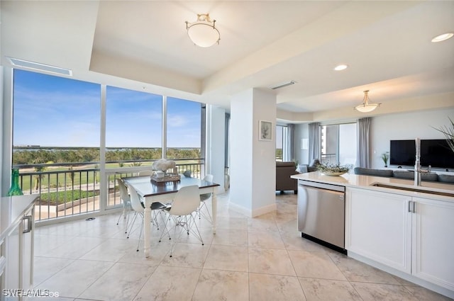 kitchen featuring open floor plan, white cabinetry, light tile patterned floors, visible vents, and dishwasher