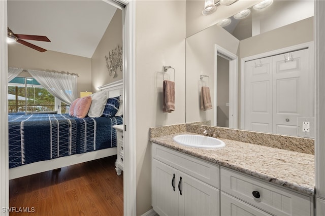 bathroom featuring lofted ceiling, ceiling fan, vanity, and wood finished floors