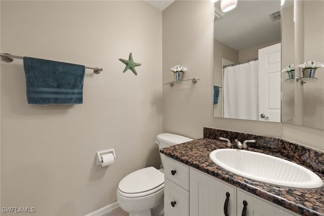 bathroom with toilet, baseboards, visible vents, and vanity