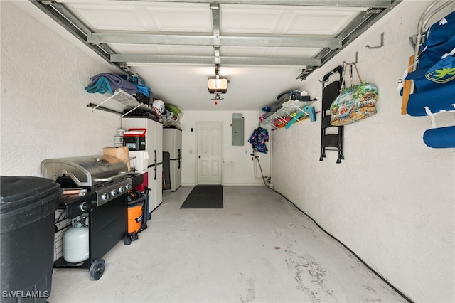 garage featuring a textured wall, fridge, electric panel, and a garage door opener