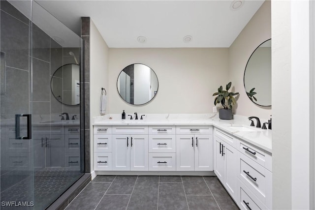 bathroom with vanity, a shower with door, and tile patterned flooring