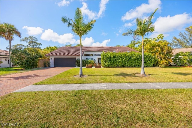 view of front of home with a garage and a front yard