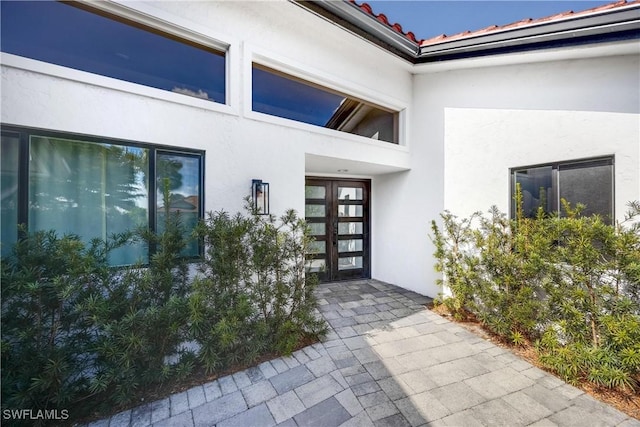 entrance to property with a patio area and french doors