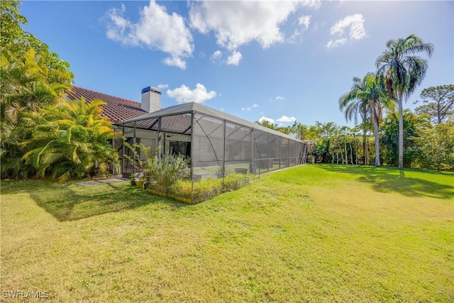 view of yard featuring glass enclosure