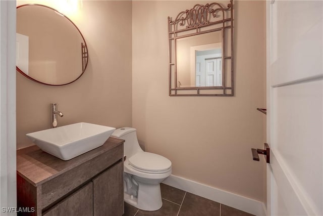 bathroom featuring tile patterned flooring, vanity, and toilet