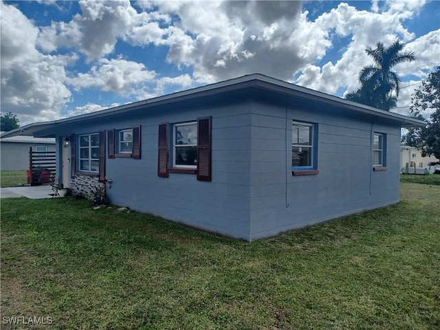 view of home's exterior with a lawn