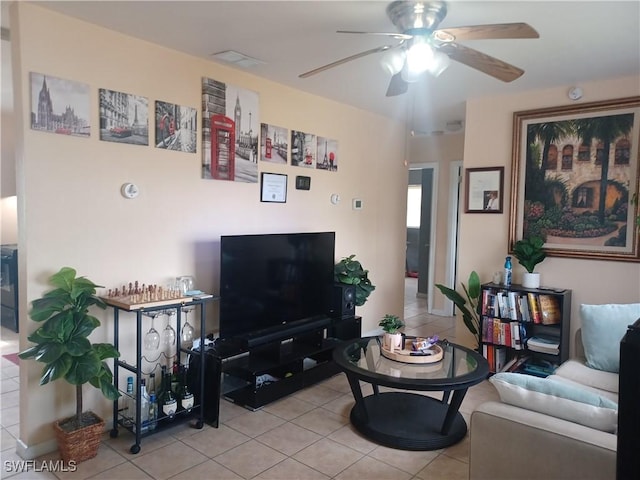 living room featuring light tile patterned flooring and ceiling fan