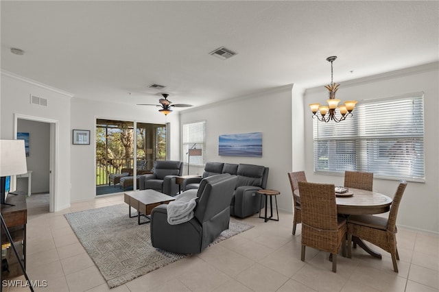 tiled living room with ceiling fan with notable chandelier and ornamental molding