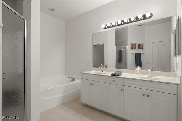 bathroom with tile patterned flooring, vanity, and independent shower and bath