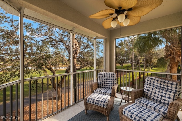 unfurnished sunroom featuring ceiling fan and a wealth of natural light