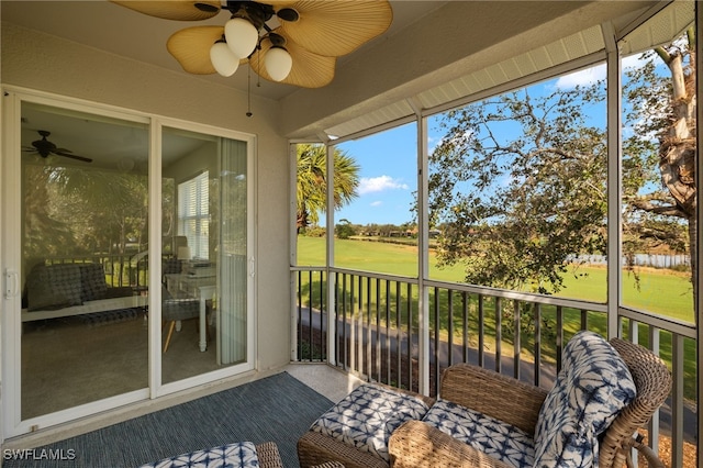 sunroom / solarium featuring ceiling fan