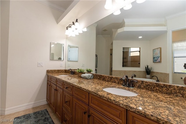 bathroom featuring tile patterned flooring, ornamental molding, vanity, and a bathtub