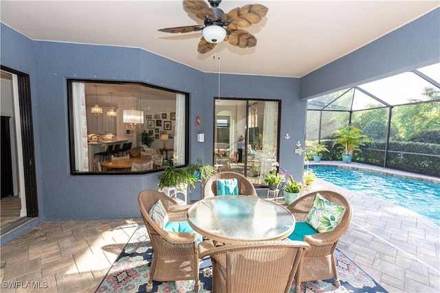 view of patio / terrace featuring ceiling fan and a lanai