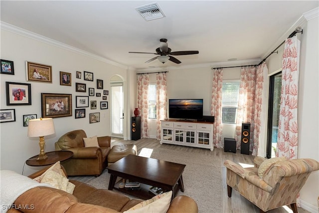 living room with ceiling fan, ornamental molding, and light hardwood / wood-style floors