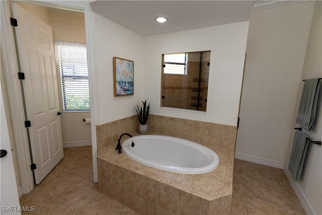 bathroom featuring tile patterned floors, shower with separate bathtub, and a wealth of natural light