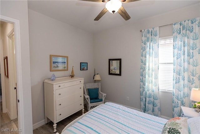 bedroom with multiple windows, hardwood / wood-style floors, and ceiling fan