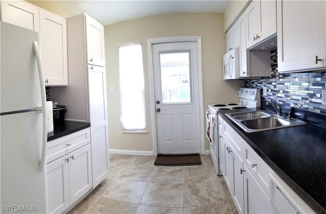 kitchen featuring white cabinetry, sink, and white appliances