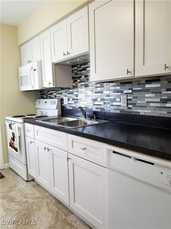 kitchen with tasteful backsplash, white appliances, sink, and white cabinets