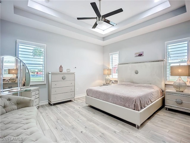 7684 County Rd 78, Fort Denaud, FL 33935 - bedroom featuring a ceiling fan, light wood-style flooring, a tray ceiling, and baseboards