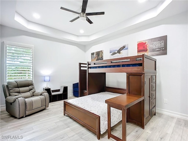 7684 County Rd 78, Fort Denaud, FL 33935 - bedroom featuring a tray ceiling, recessed lighting, light wood-style floors, ceiling fan, and baseboards