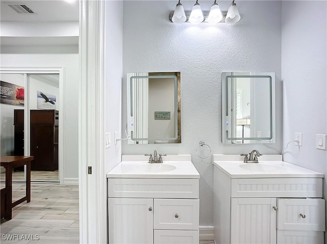 7684 County Rd 78, Fort Denaud, FL 33935 - full bathroom featuring two vanities, a sink, and visible vents
