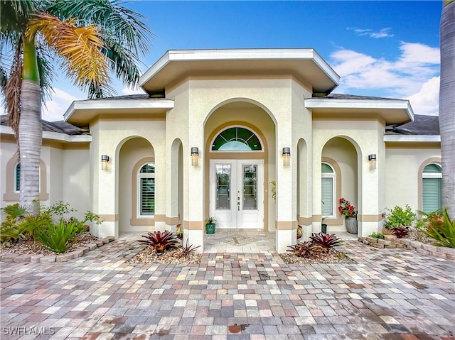 doorway to property with french doors and stucco siding