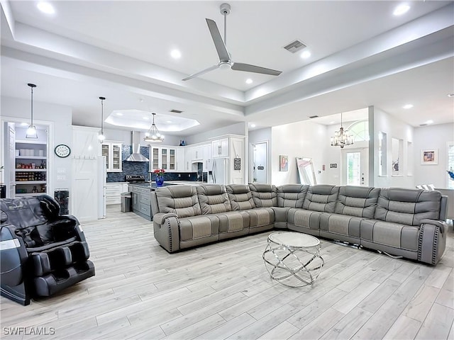 7684 County Rd 78, Fort Denaud, FL 33935 - living area with recessed lighting, ceiling fan with notable chandelier, visible vents, light wood-style floors, and a tray ceiling