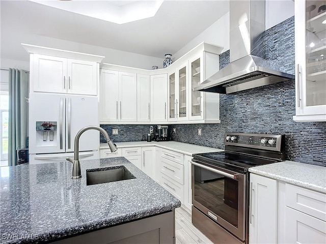 7684 County Rd 78, Fort Denaud, FL 33935 - kitchen featuring stainless steel electric range oven, glass insert cabinets, white cabinets, white fridge with ice dispenser, and wall chimney exhaust hood