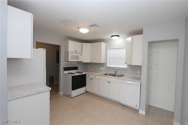 kitchen with white cabinetry, sink, and white appliances