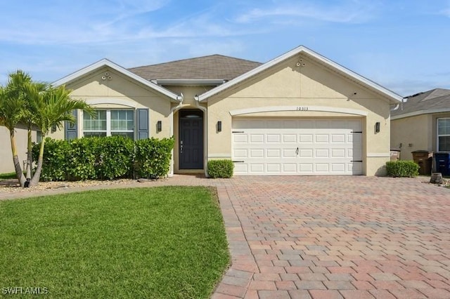 single story home with a garage and a front lawn