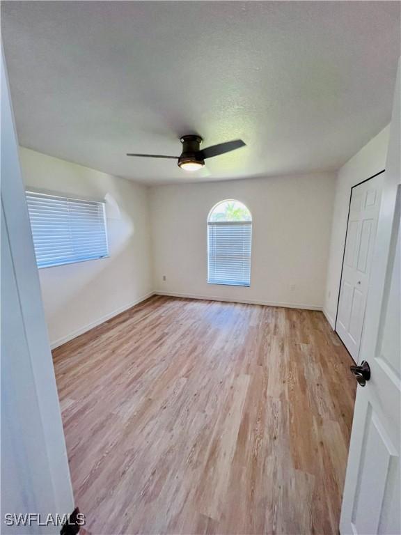 unfurnished bedroom featuring ceiling fan and light hardwood / wood-style floors