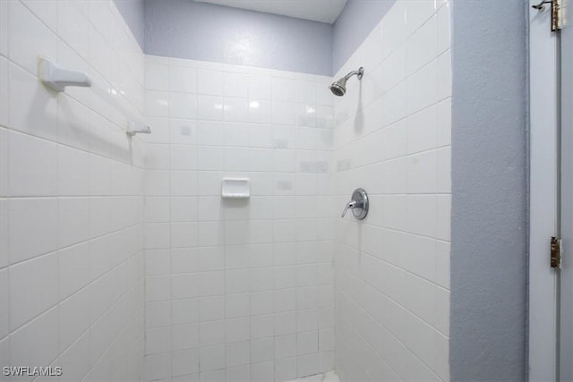 bathroom with a tile shower