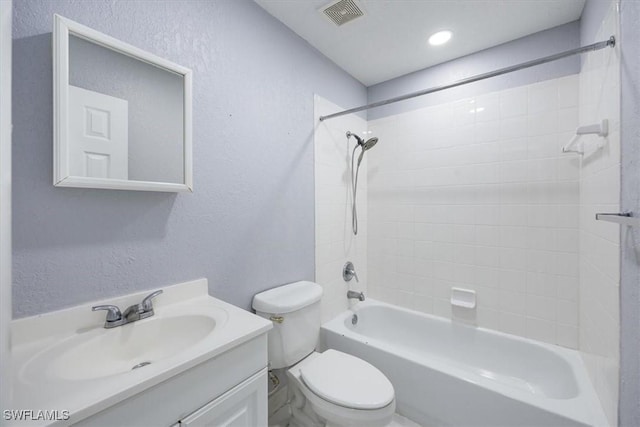 full bathroom with toilet, vanity, and tiled shower / bath