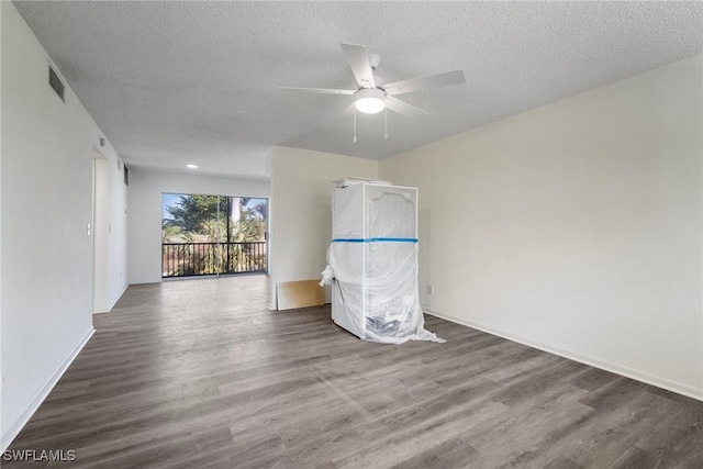 spare room with hardwood / wood-style flooring, ceiling fan, and a textured ceiling