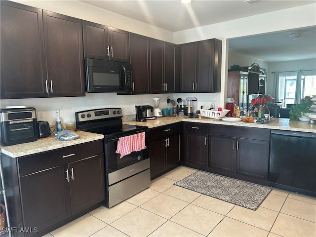 kitchen featuring dark brown cabinetry, sink, light tile patterned floors, and black appliances