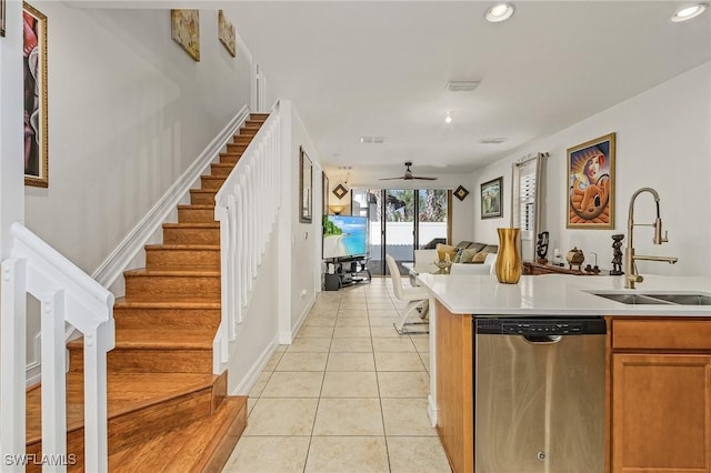 kitchen featuring sink, light tile patterned floors, dishwasher, and ceiling fan