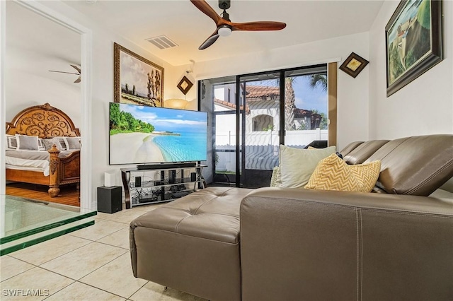 tiled living room with ceiling fan