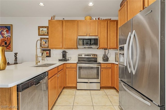 kitchen with stainless steel appliances, kitchen peninsula, sink, and light tile patterned floors