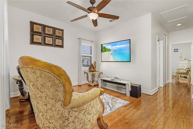 living area featuring ceiling fan and wood-type flooring