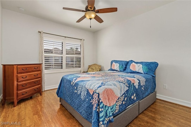 bedroom featuring wood-type flooring and ceiling fan