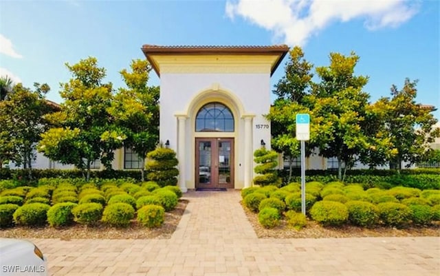 view of exterior entry featuring french doors