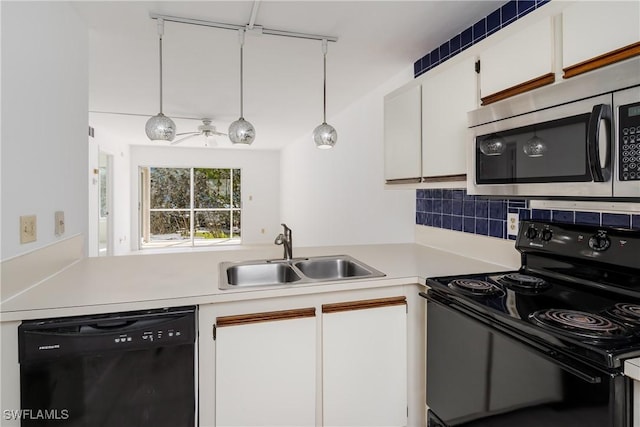 kitchen with decorative light fixtures, tasteful backsplash, white cabinetry, sink, and black appliances