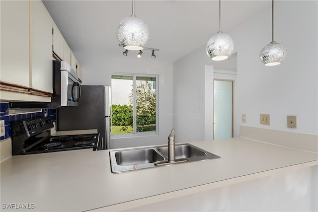 kitchen with black range with electric stovetop, decorative light fixtures, sink, and white cabinets