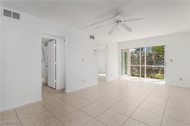 empty room featuring light tile patterned flooring and ceiling fan