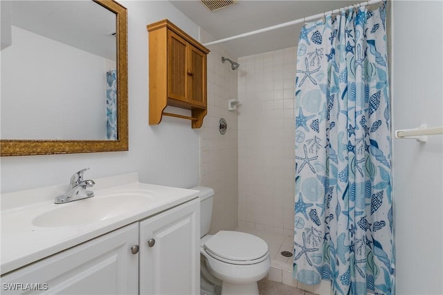 bathroom featuring vanity, curtained shower, and toilet